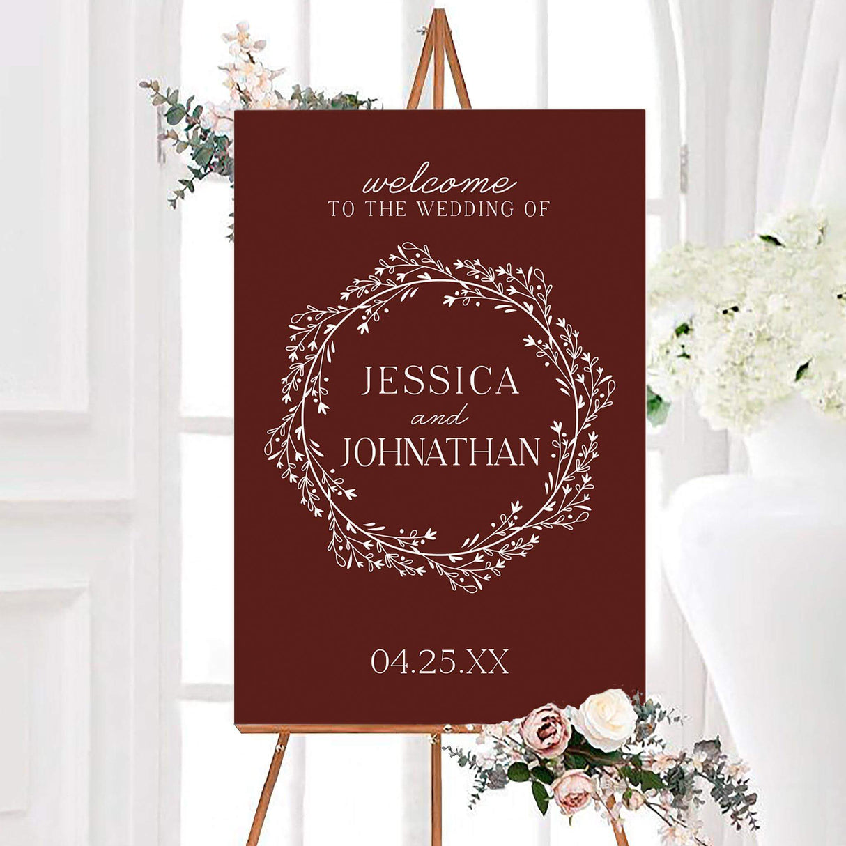 Marsala wreath wedding welcome sign featuring a deep marsala background with an intricate white botanical wreath and personalized names. An elegant botanical design created to welcome guests to a wedding ceremony or reception.