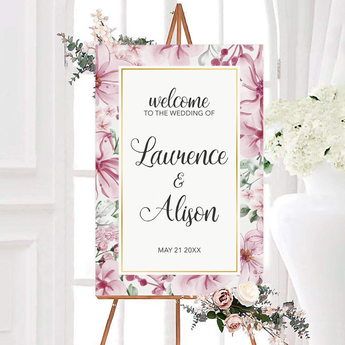 Floral frame wedding welcome sign featuring mauve and pink watercolor flowers with an elegant gold frame. Personalized script lettering displays the couple’s names and wedding date.
