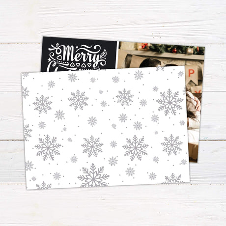 Personalized Merry Christmas photo collage card with bold script typography and space for family photos and custom name. back side