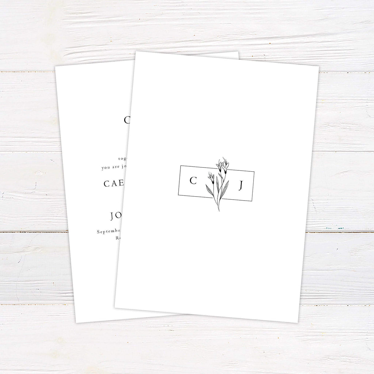 Minimalist wedding invitation with hand-drawn black floral illustration, monogram initials, and elegant serif and script text on white background - back