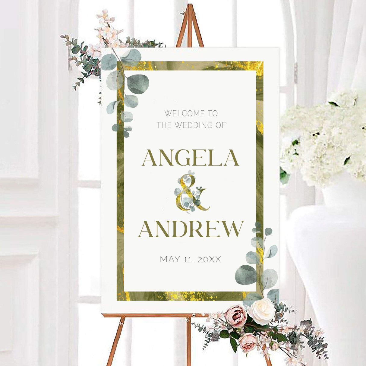 Personalized minimalist greenery wedding welcome sign with watercolor eucalyptus greenery, olive green and gold border, and large serif couple names. A decorative gold ampersand and wedding date complete the elegant botanical design.
