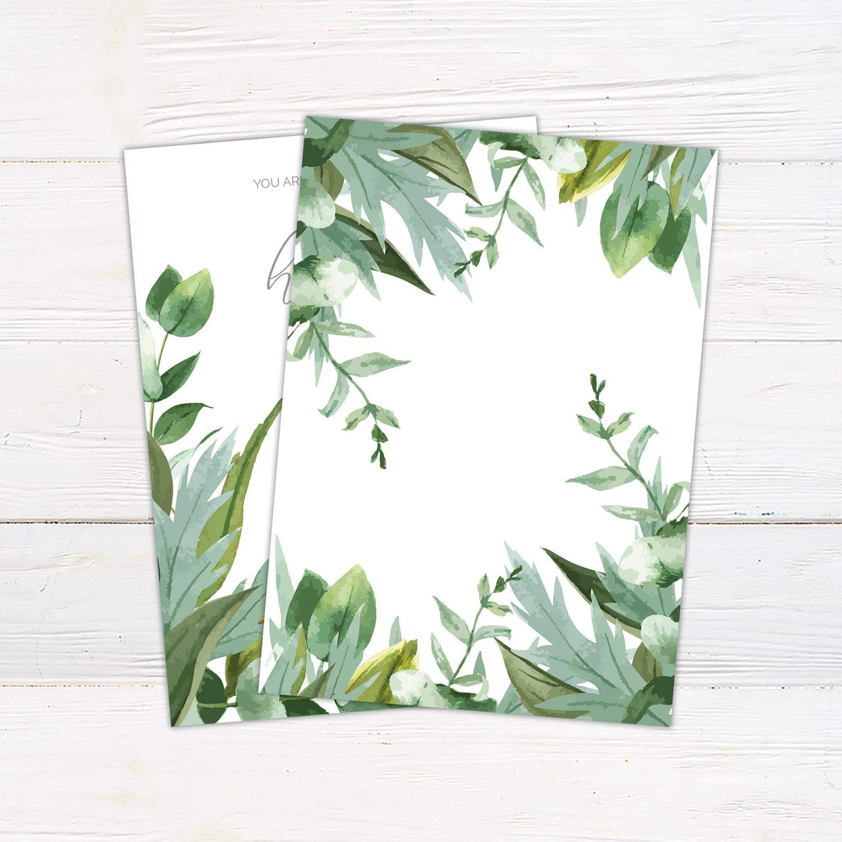 Wedding invitation with watercolor mint green and olive leaves, elegant script and sans-serif fonts, and minimalist layout on a white background - back