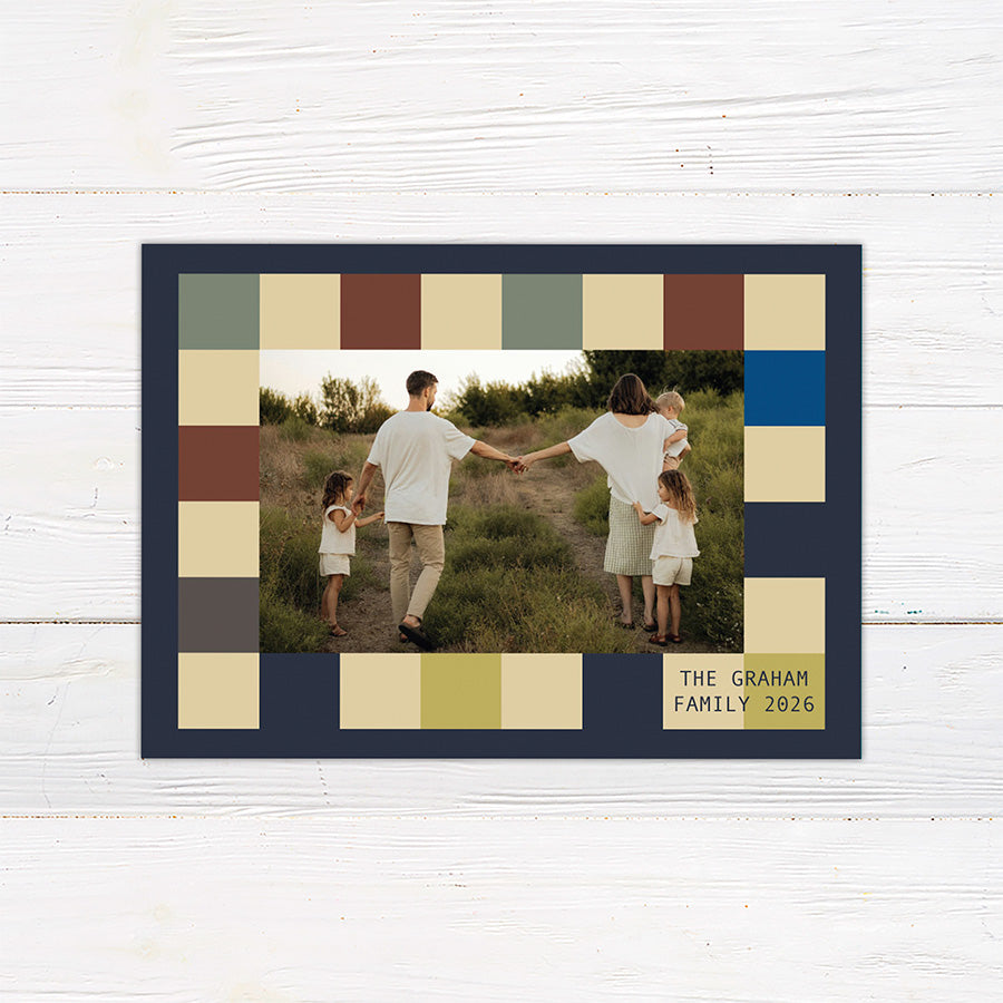 Personalized holiday card featuring a geometric color block pattern with a Happy Holidays greeting and custom family details. Coordinating options include a family photo layout and personalized seasonal message.
