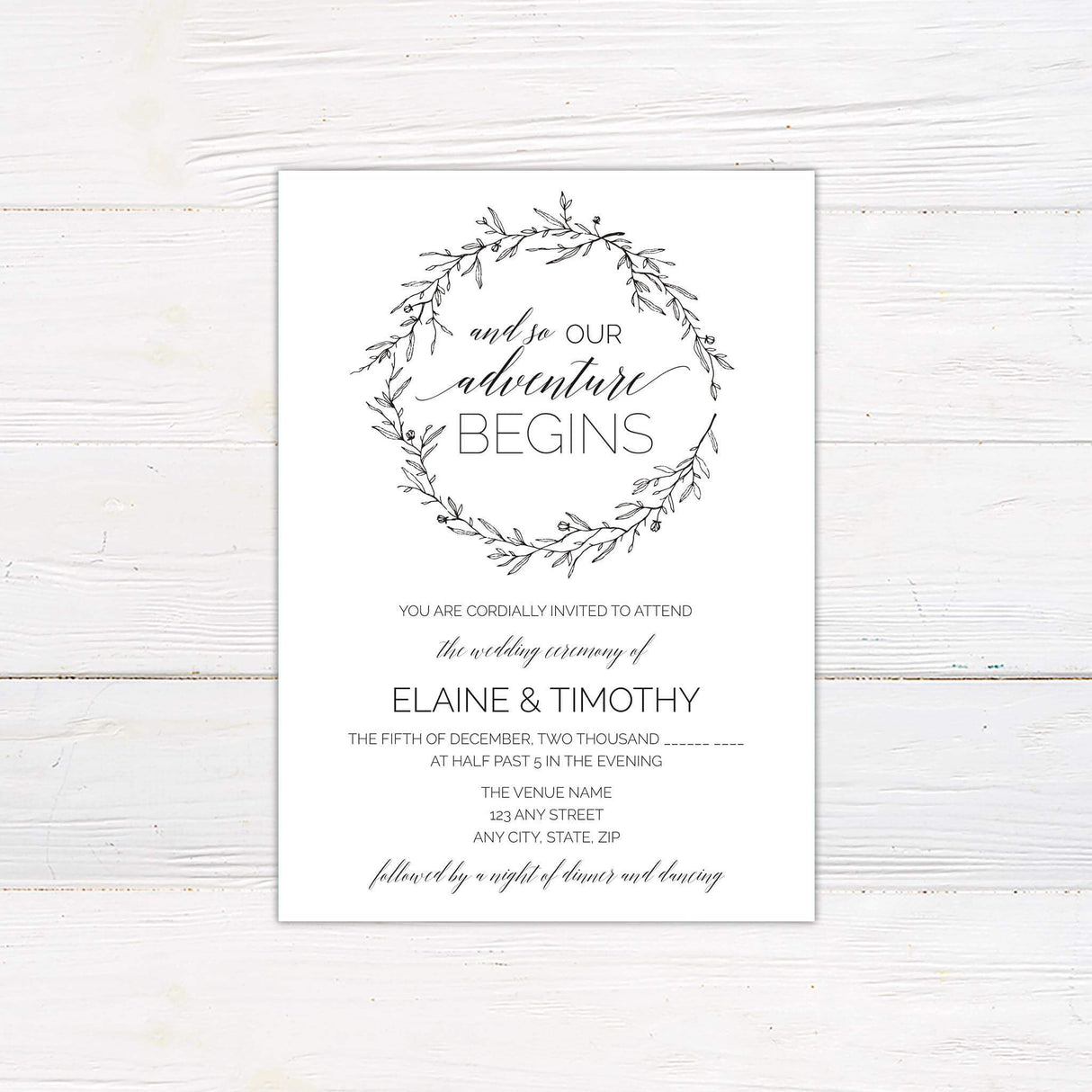 Rustic black and white wedding invitation with botanical wreath and “And so our adventure begins” quote in script and serif fonts