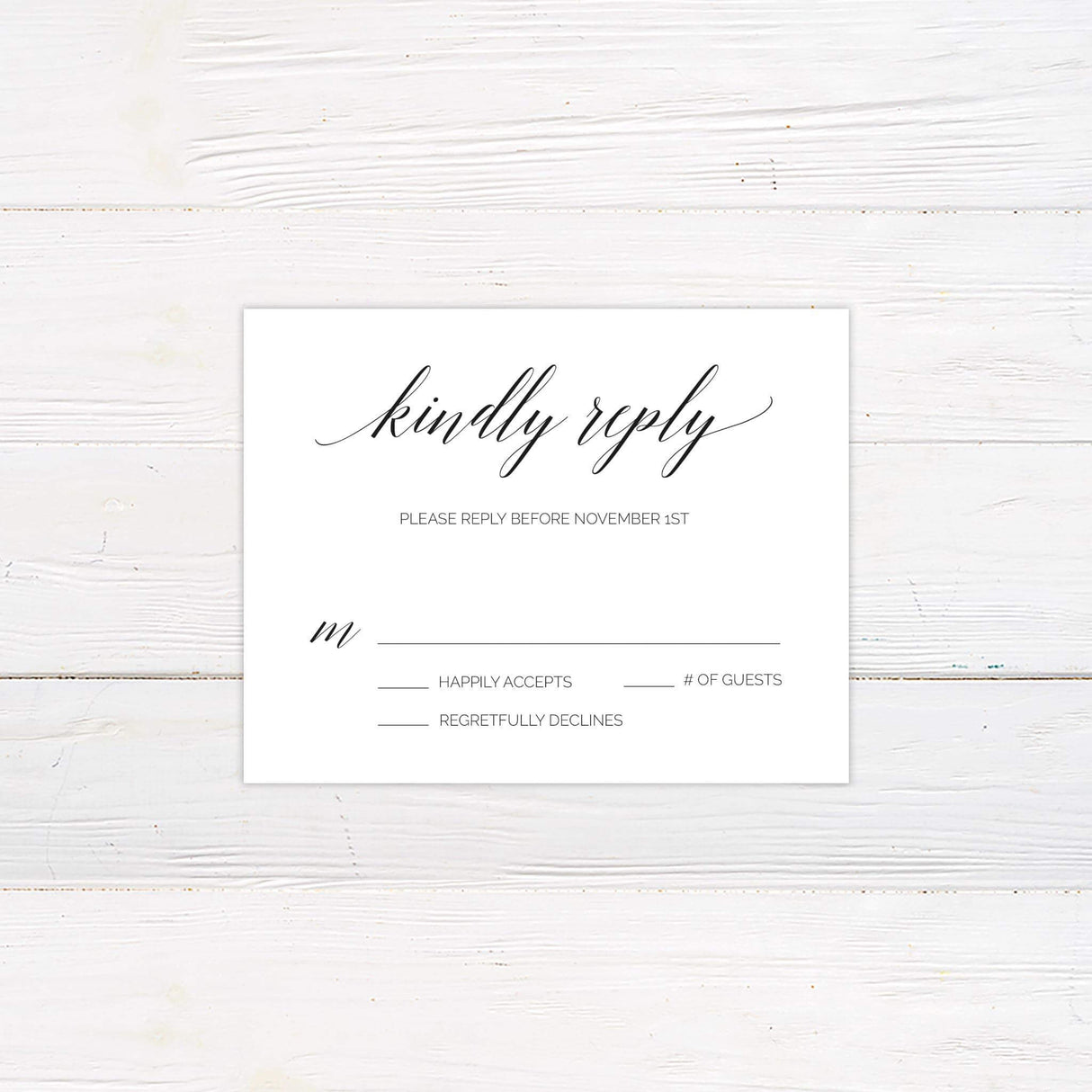 Black and white RSVP card with minimalist script and serif fonts and botanical wreath detail, matching rustic wedding invitation suite.