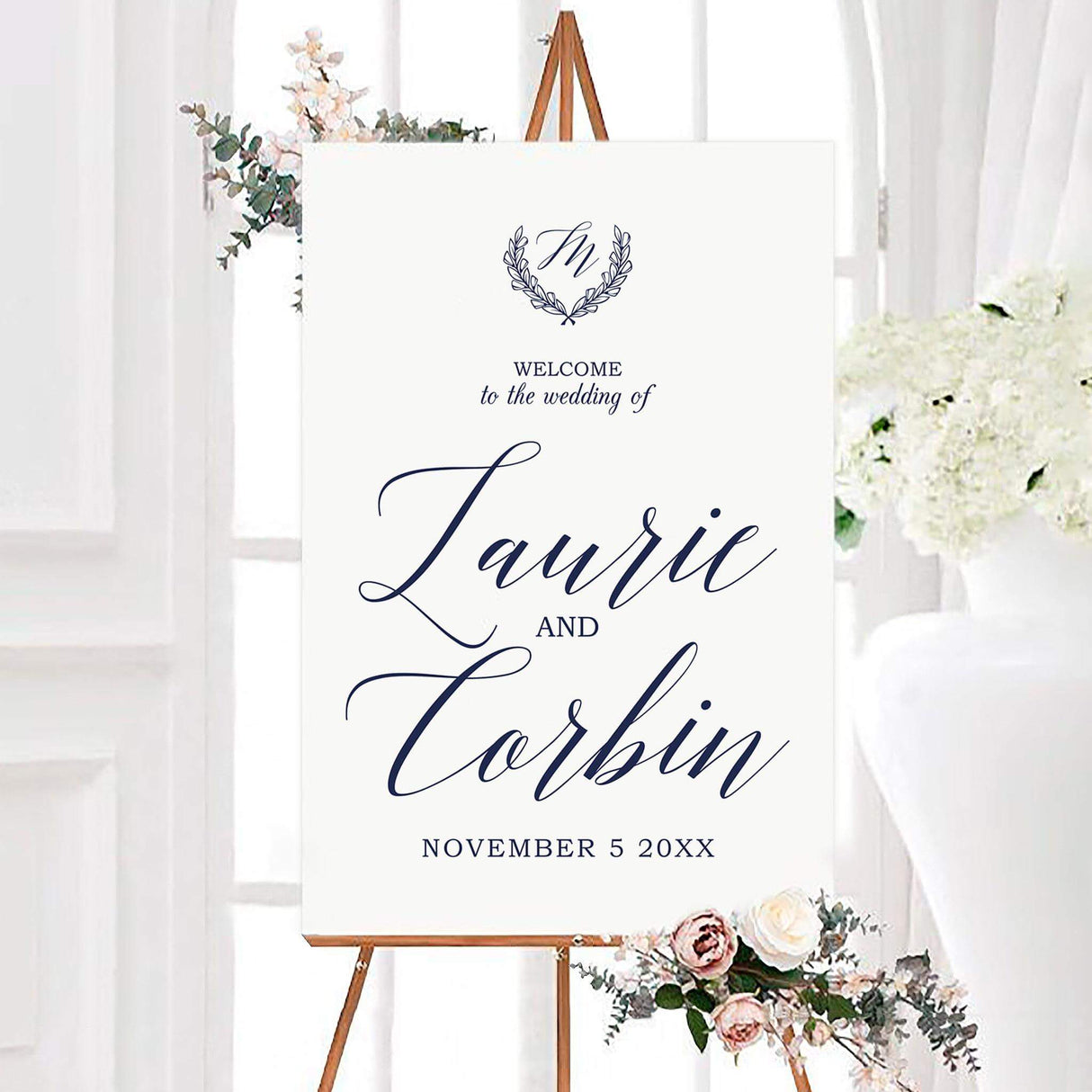 Elegant monogram crest wedding welcome sign featuring a custom monogram initial inside a delicate laurel wreath. Large script names and a personalized wedding date complete the clean, sophisticated design.