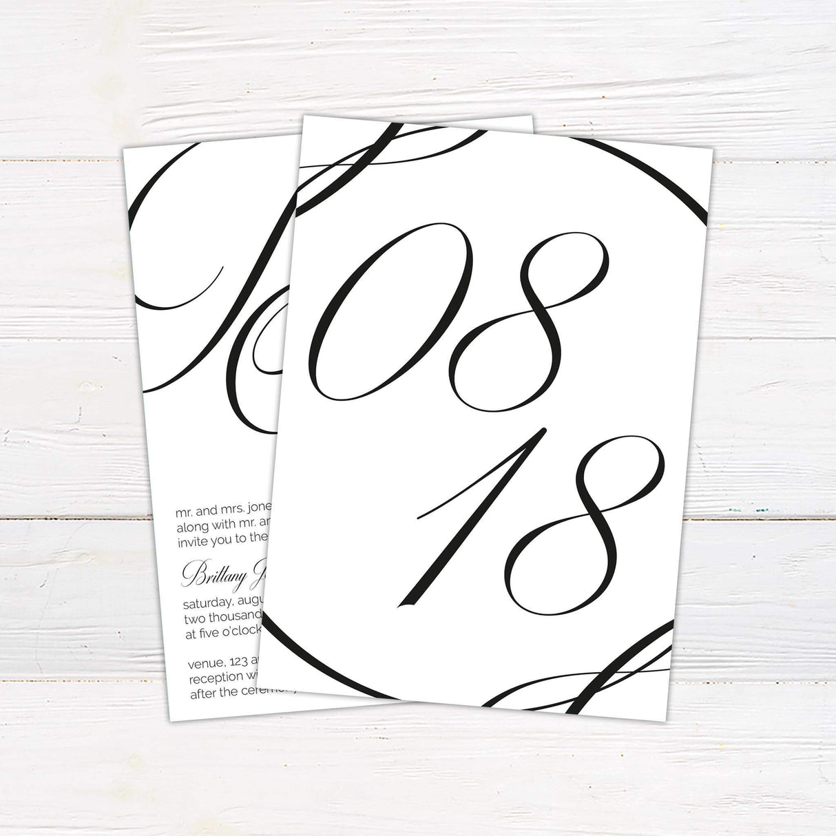 Modern wedding invitation with oversized script monogram, minimalist layout, and elegant serif and script fonts on a white background - back side with date