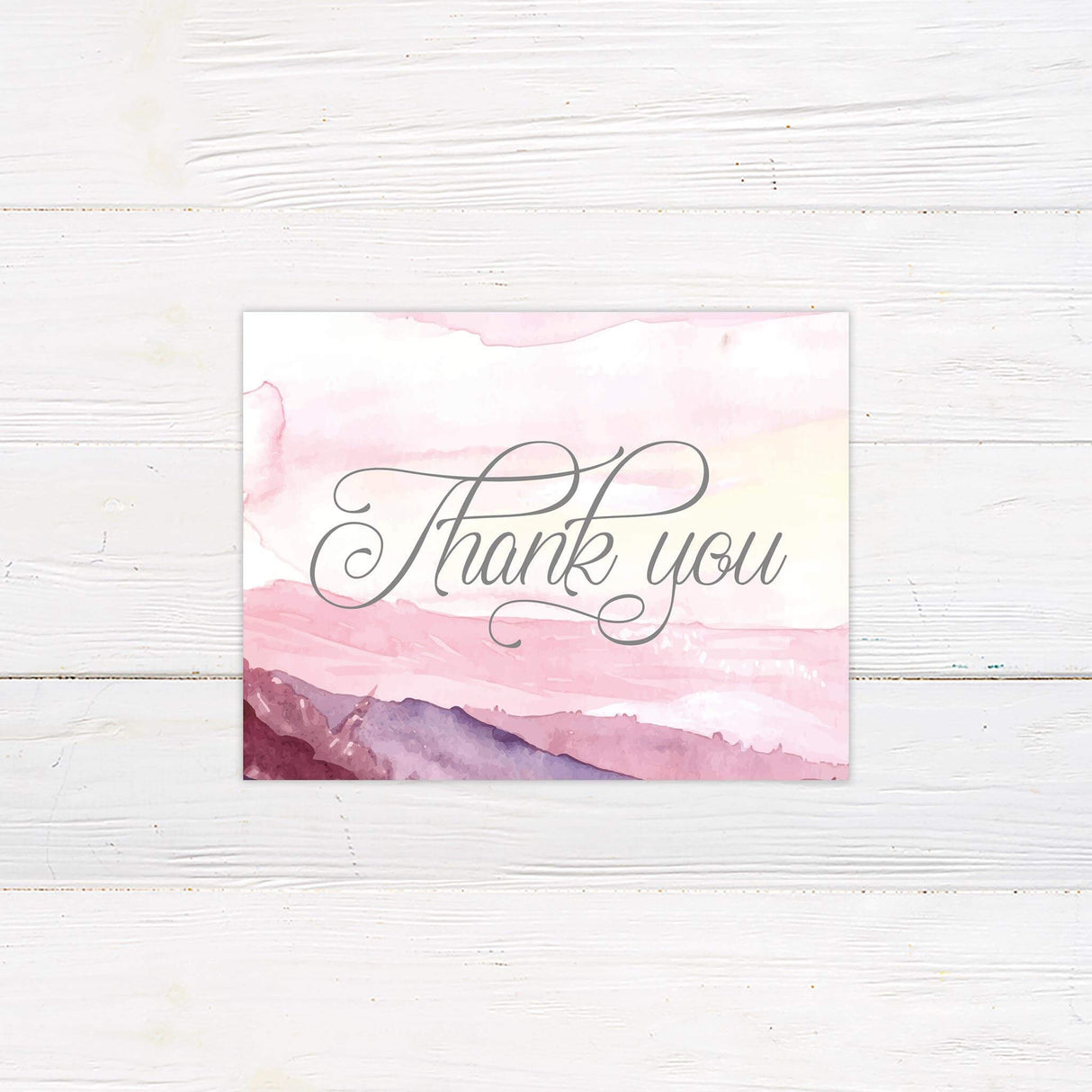 Thank you card with pink and purple watercolor mountain artwork and graceful script text, part of the matching romantic wedding suite.