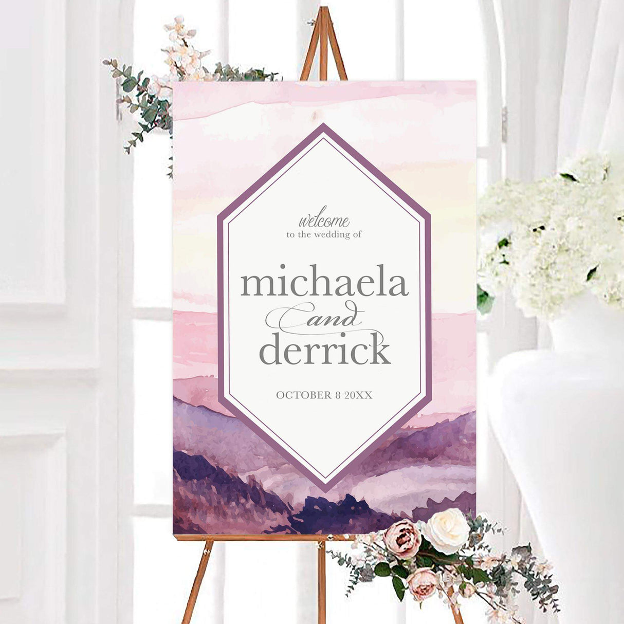 Mountains at Dusk wedding welcome sign featuring a soft watercolor mountain landscape and a geometric center frame. The personalized design includes the couple’s names and wedding date with elegant script and classic lettering.