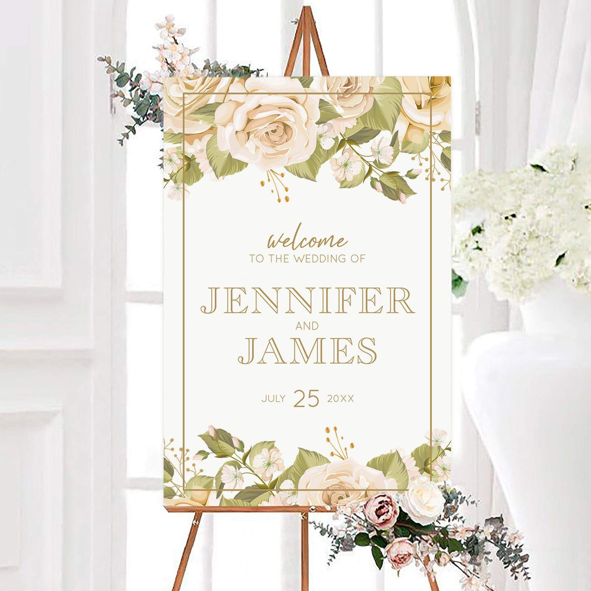 Wedding welcome sign with blush and cream roses, greenery, and elegant serif script fonts in a gold border