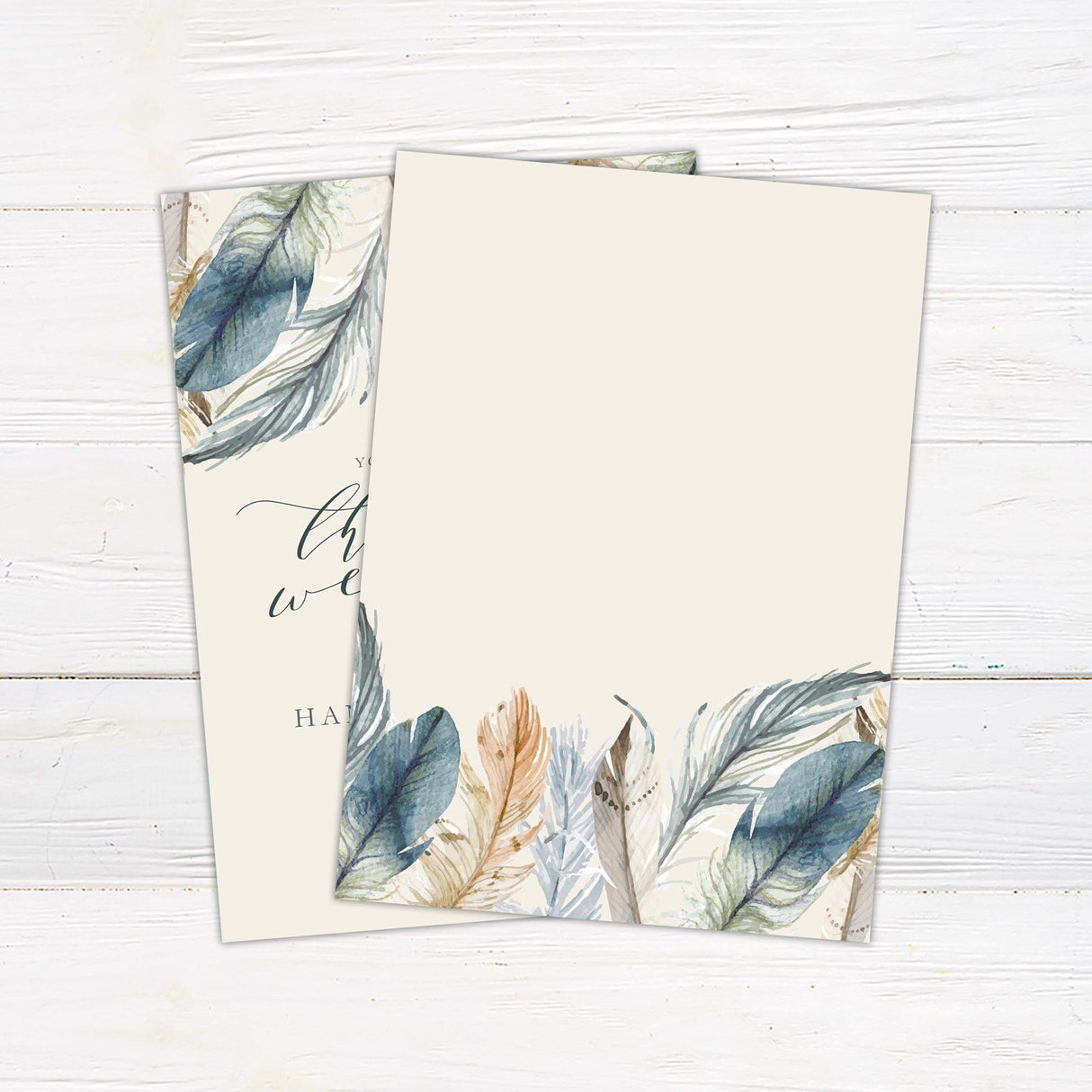 A wedding invitation with a soft, neutral background features elegant watercolor feathers in shades of blue, beige, and brown adorning the top. The text is arranged in a mix of flowing script and serif fonts, creating a refined and bohemian feel. Event details, including the date, time, and venue, are displayed in a balanced layout. This design exudes rustic elegance, making it perfect for boho, nature-inspired, or whimsical wedding celebrations. Back