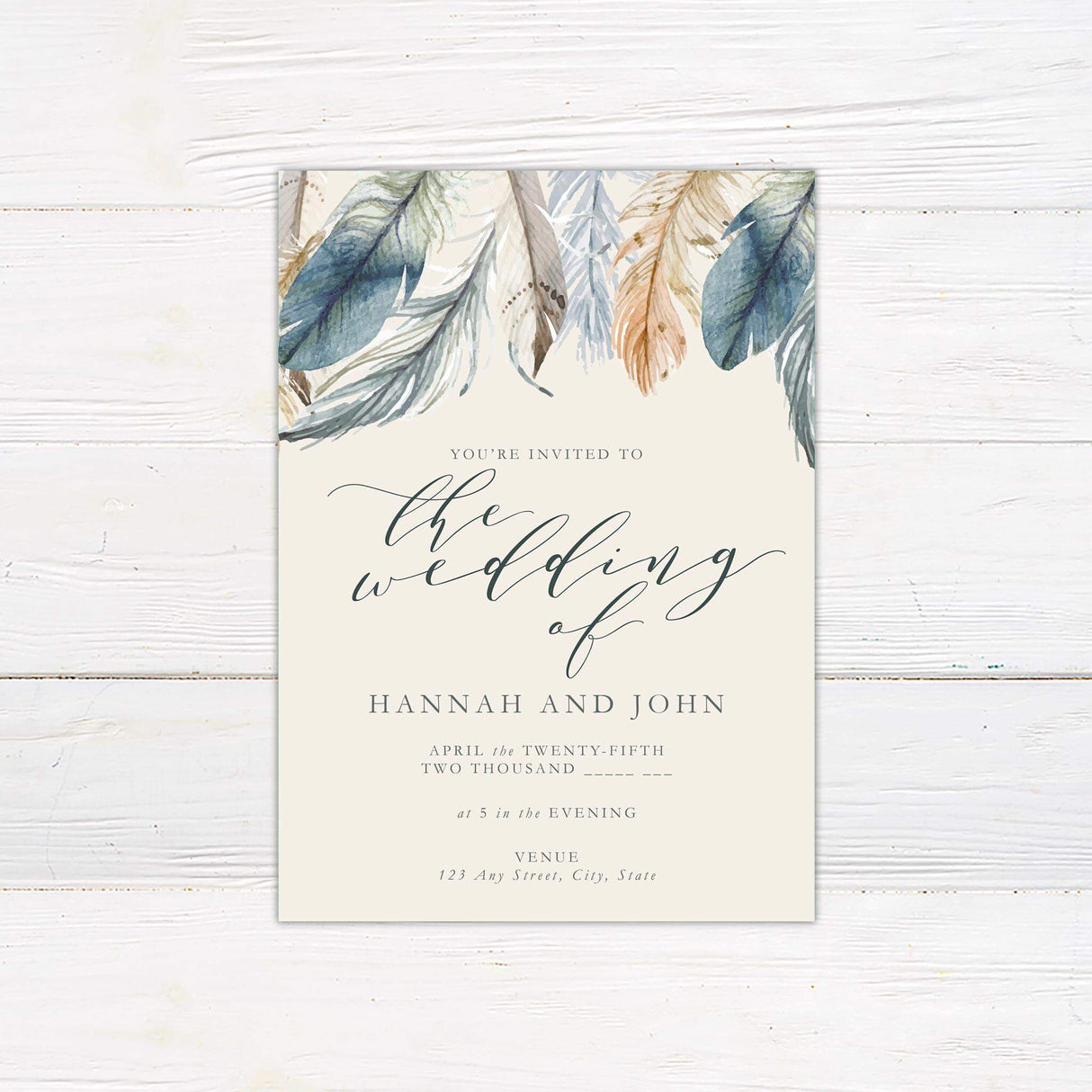 Boho wedding invitation with watercolor feathers in blue, beige, and rust, elegant script and serif fonts on ivory background