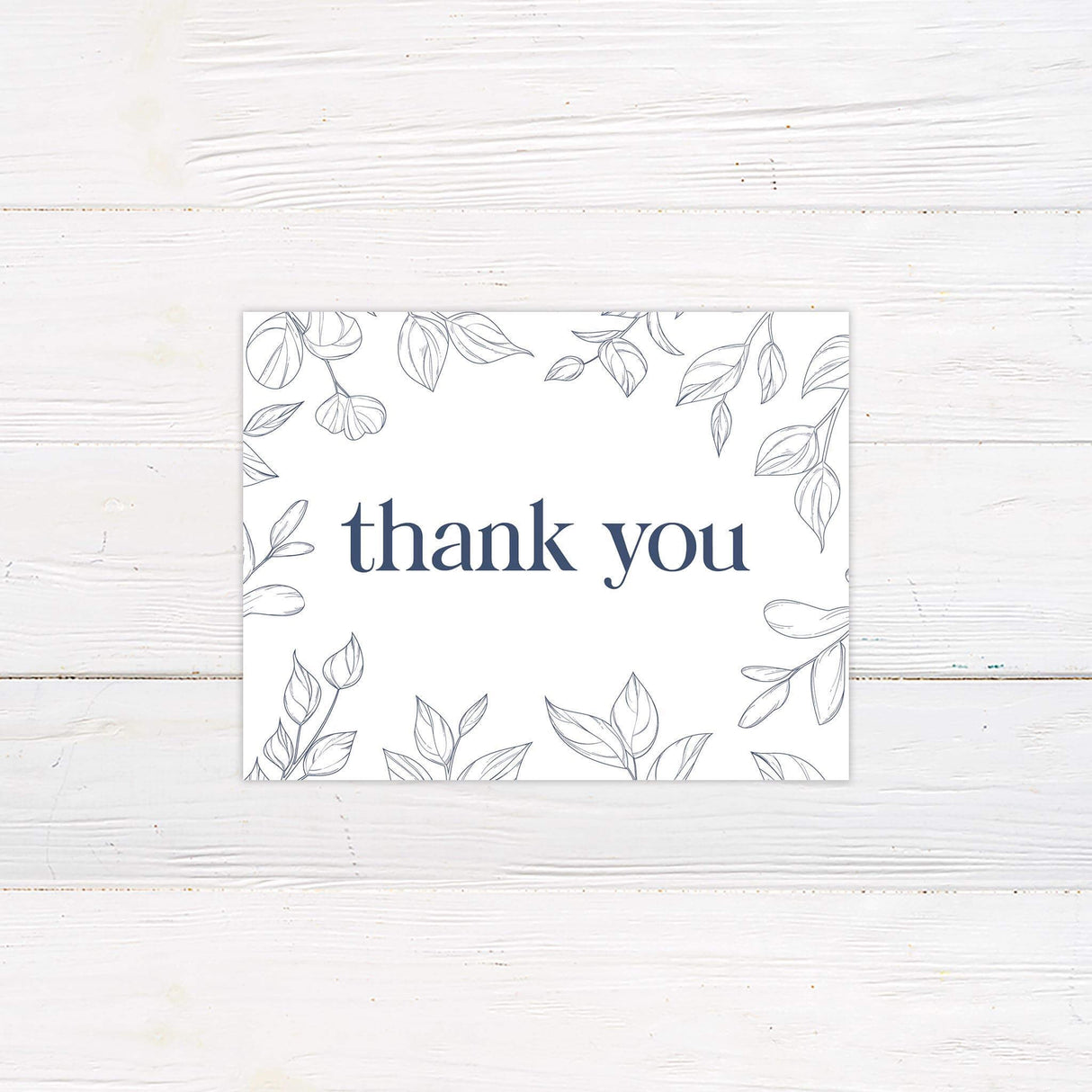 Thank you card with simple navy leaf illustrations and elegant handwritten-style script.