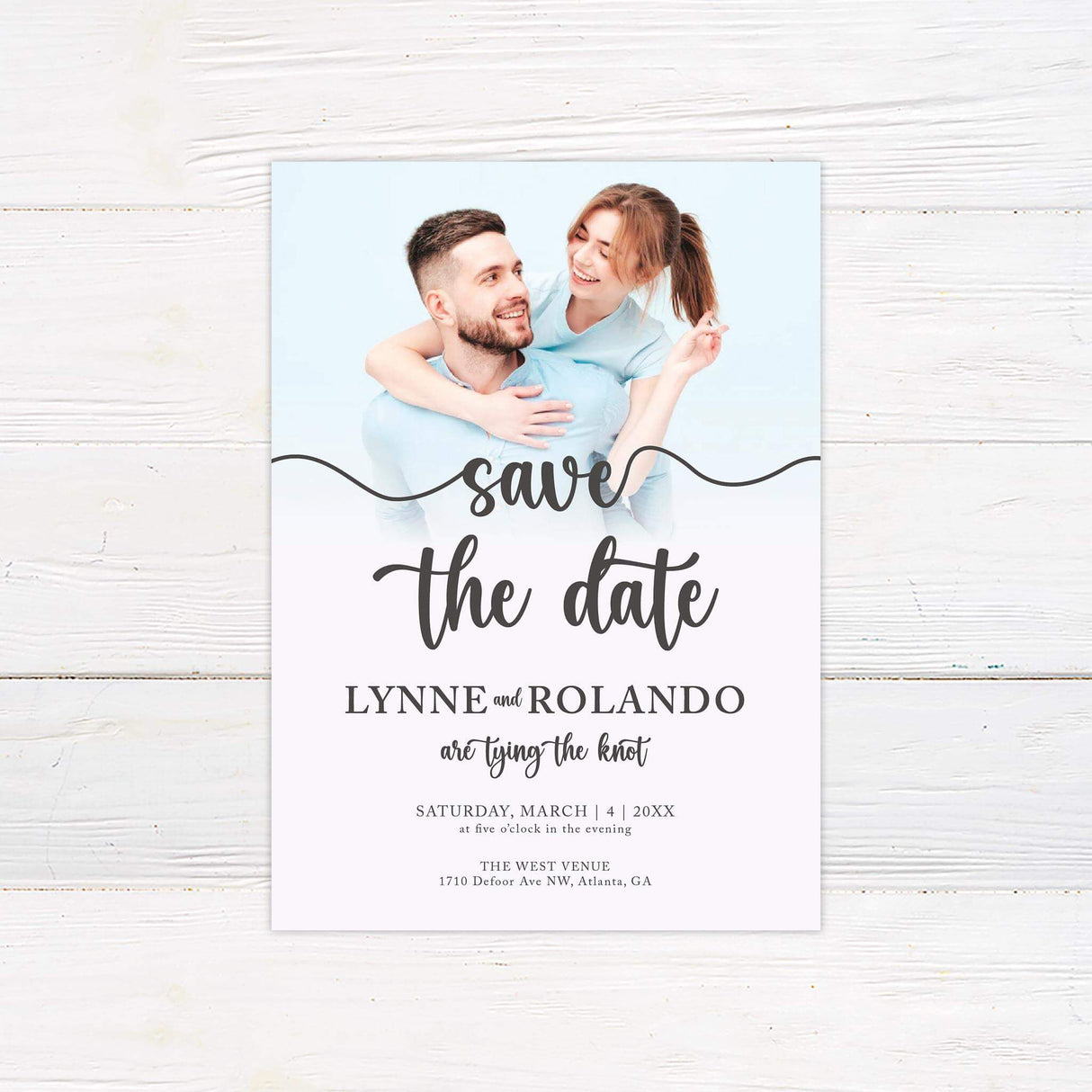 Save the date card with neutral background and elegant mix of handwritten and serif typography.