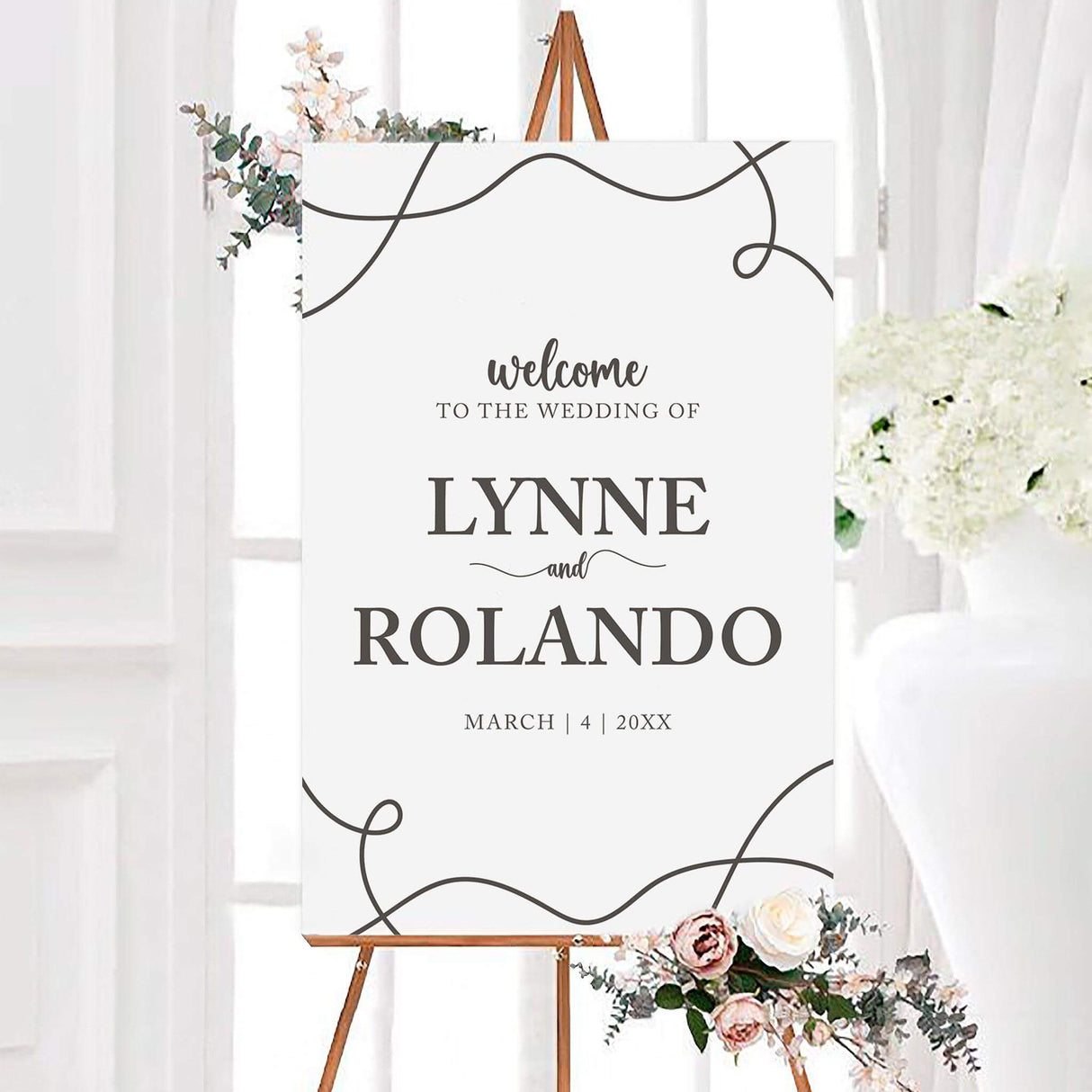 Nothing fancy wedding welcome sign with large charcoal serif names, elegant script accents, and abstract looping line details. The personalized black and white design includes the couple’s names and wedding date.