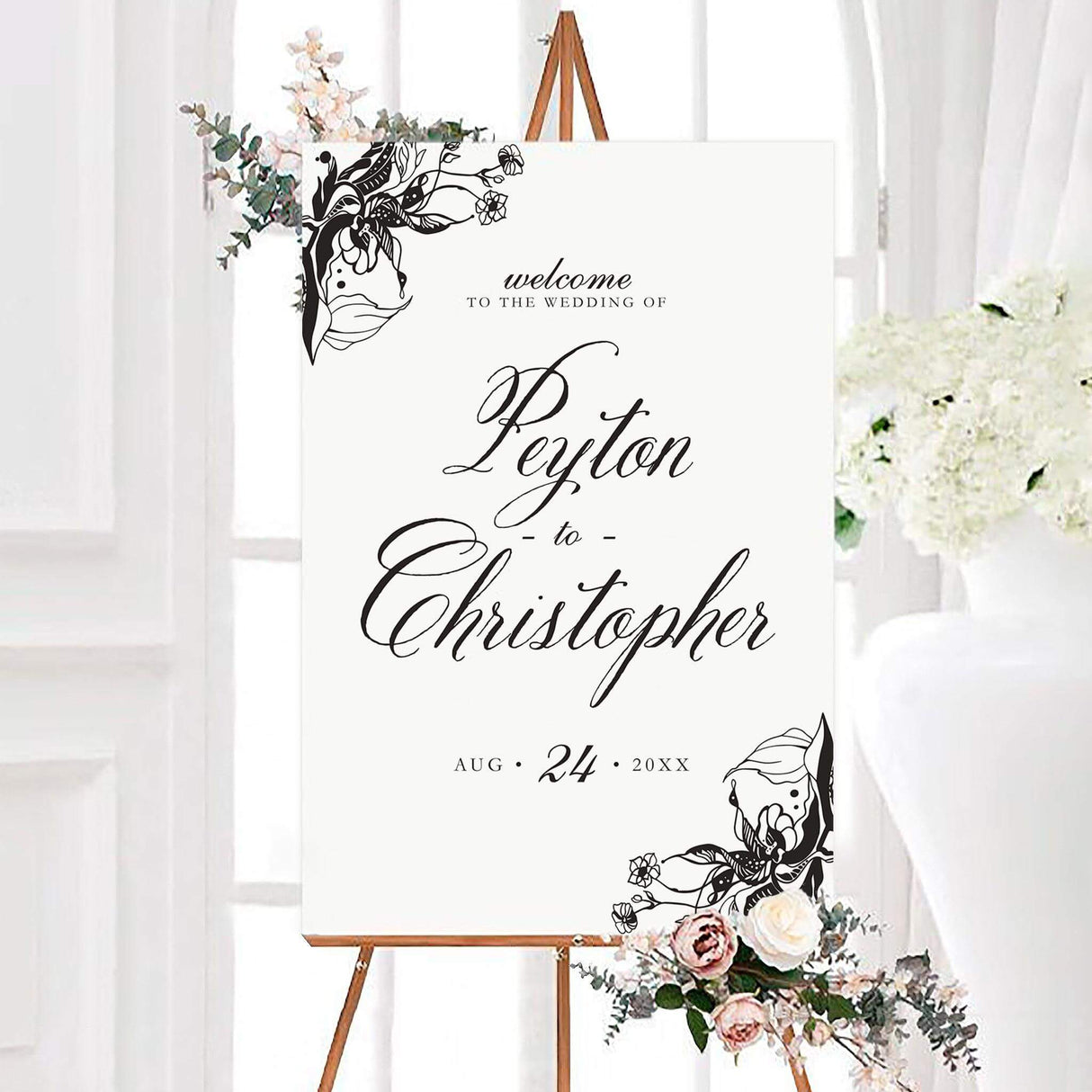 Black and white nouveau floral wedding welcome sign with ornate hand-drawn floral corner illustrations and elegant script lettering. The personalized design features the couple’s names and wedding date.