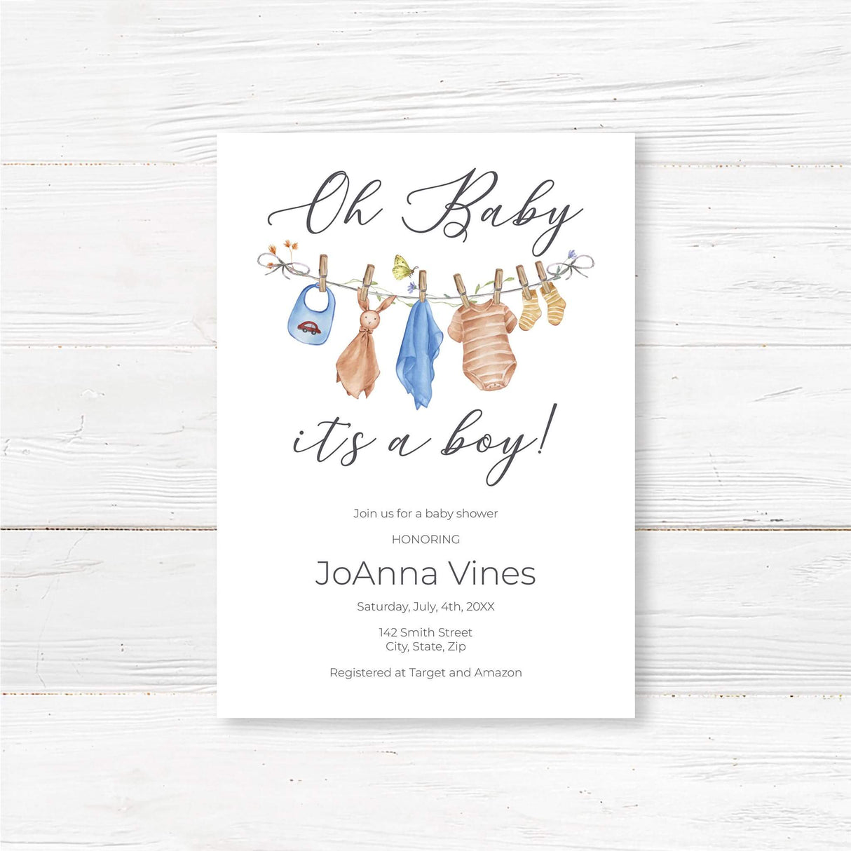 Printed baby shower invitation featuring a watercolor baby clothesline with adorable blue baby outfits, bibs, and socks. The text reads 'Oh Baby, It's a Boy!' in an elegant script font. Perfect for a rustic, boho, or vintage baby shower. Customizable with honoree’s name, date, time, and location. Printed on thick premium cardstock and includes envelopes. Ideal for a gender reveal, baby sprinkle, or classic boy baby shower theme
