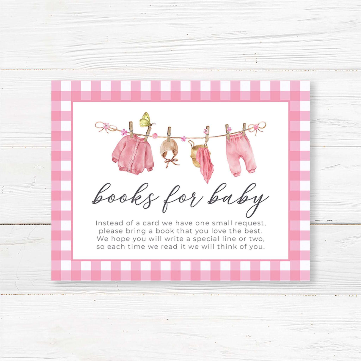 Books for baby insert card with a pink watercolor baby clothesline design. Encourages guests to bring a book instead of a card for the baby girl