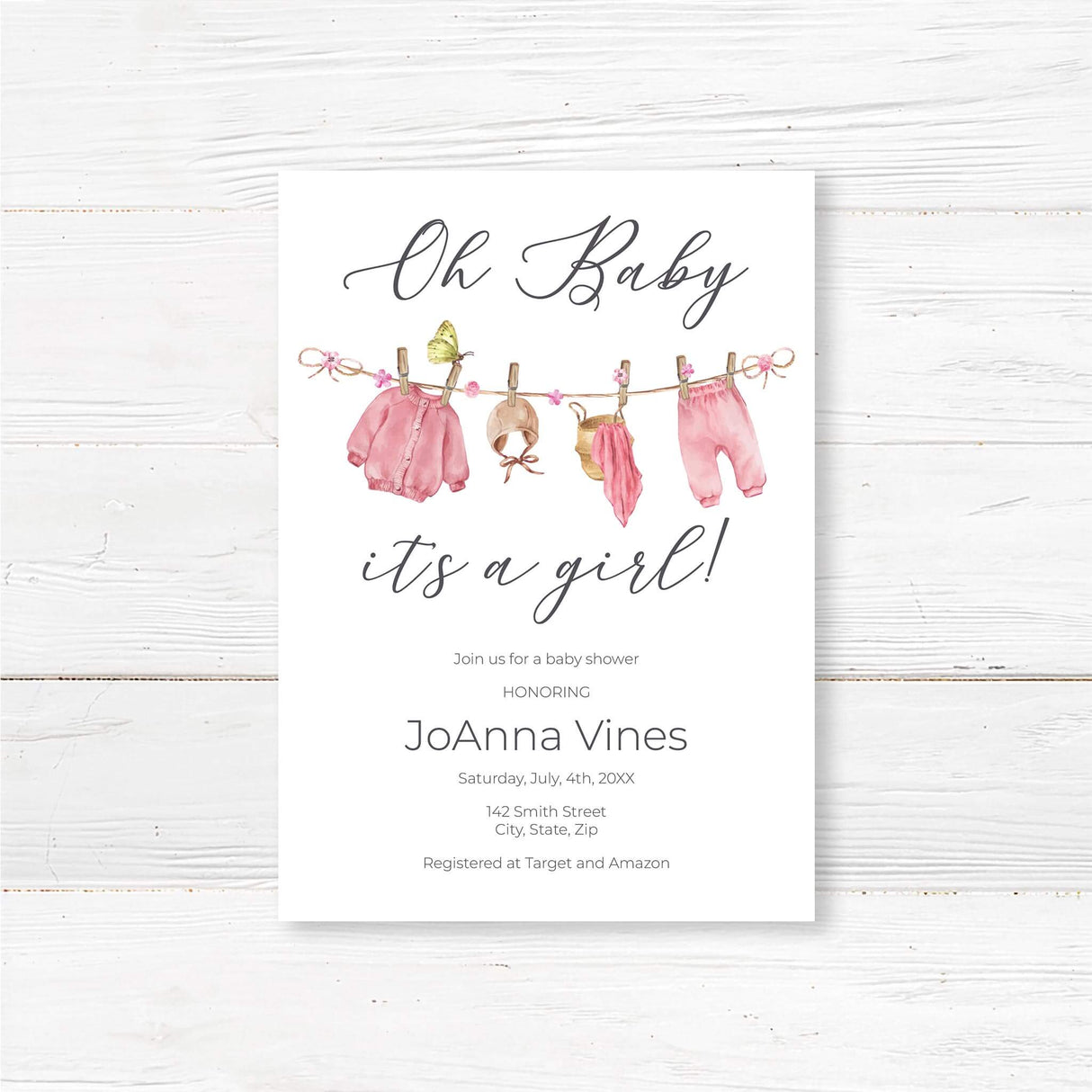 Printed baby shower invitation featuring a watercolor pink baby clothesline design with delicate floral accents. Perfect for a baby girl shower or sprinkle.