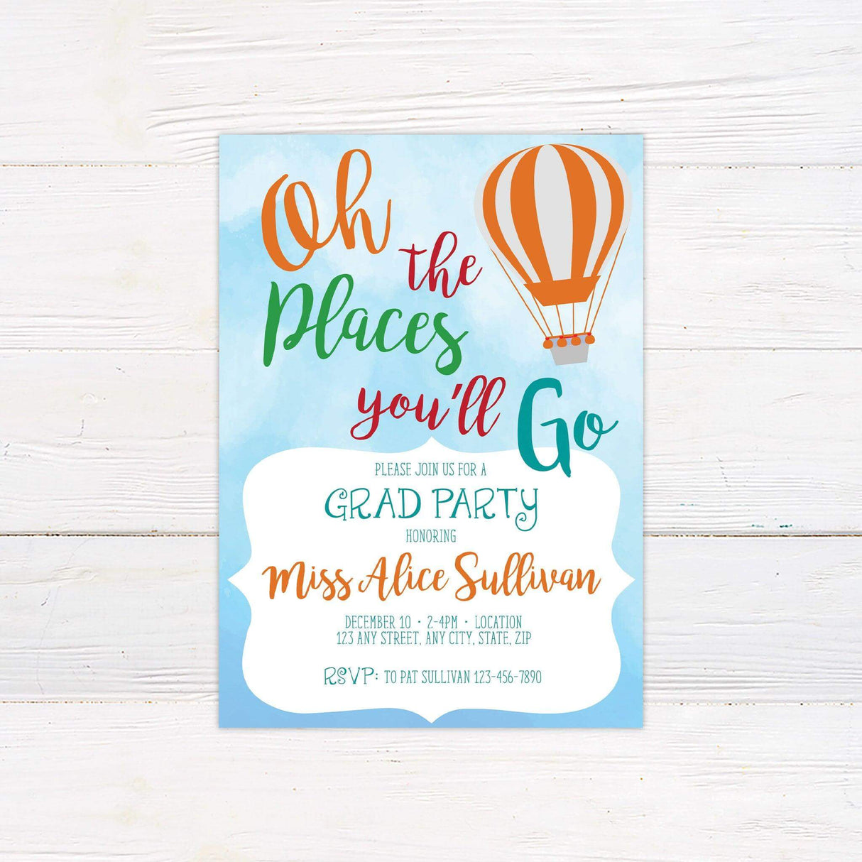 Graduation party invitation with a sky-blue watercolor background, colorful typography reading "Oh, the Places You'll Go," and an orange hot air balloon. Features event details in a stylish mix of script and print fonts, creating a cheerful and festive design.