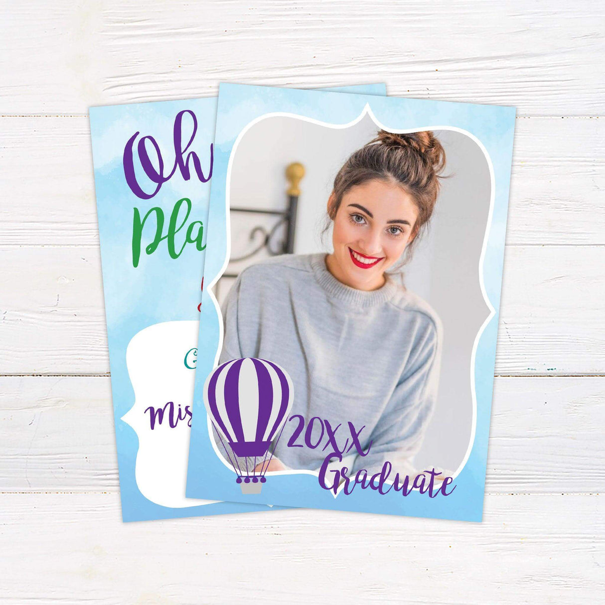 Graduation announcement with a light blue watercolor border featuring a photo of the graduate, a hot air balloon, and bold script text reading "20XX Graduate." A celebratory design perfect for announcing a milestone achievement.