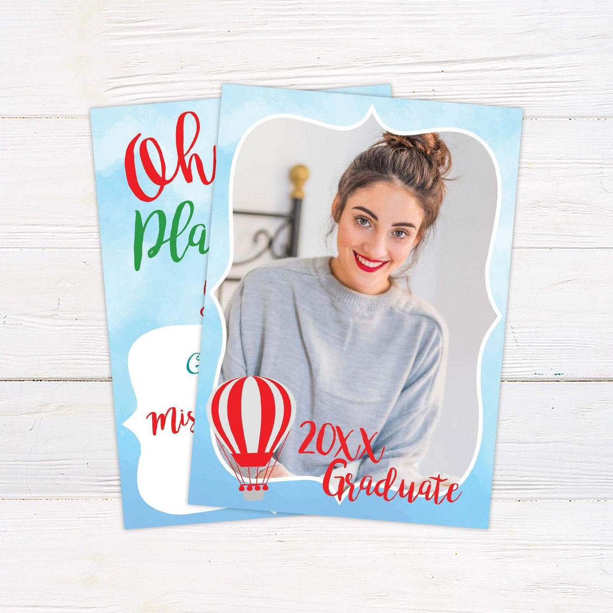 Graduation announcement with a light blue watercolor border featuring a photo of the graduate, a hot air balloon, and bold script text reading "20XX Graduate." A celebratory design perfect for announcing a milestone achievement.