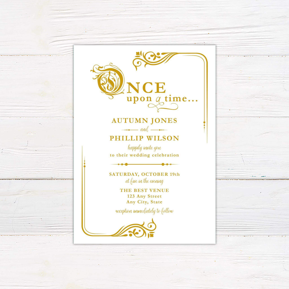 Fairy tale wedding invitation with “Once Upon a Time” script in gold and ornate storybook flourishes on a white background.