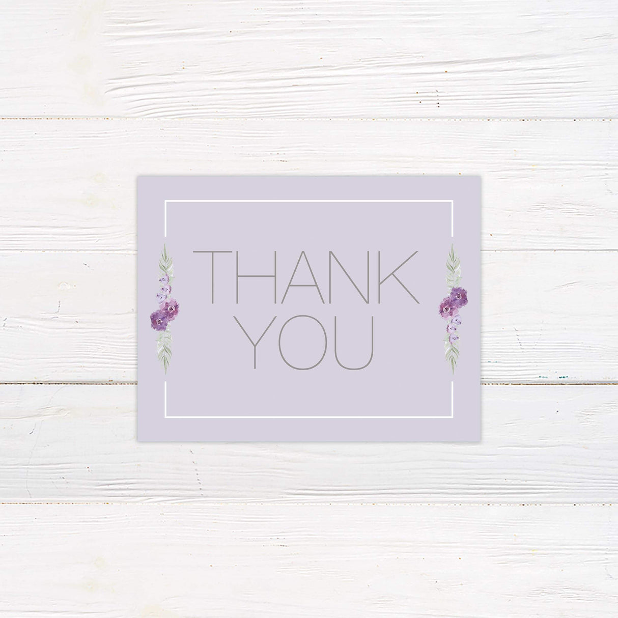 Thank you card with soft lavender background and purple floral details in a clean modern layout.