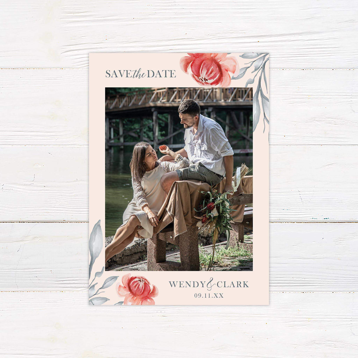 Beautiful orient florals in orange tone and gray leaves as a border to a peach background. Couples Photograph in the center of the design.
