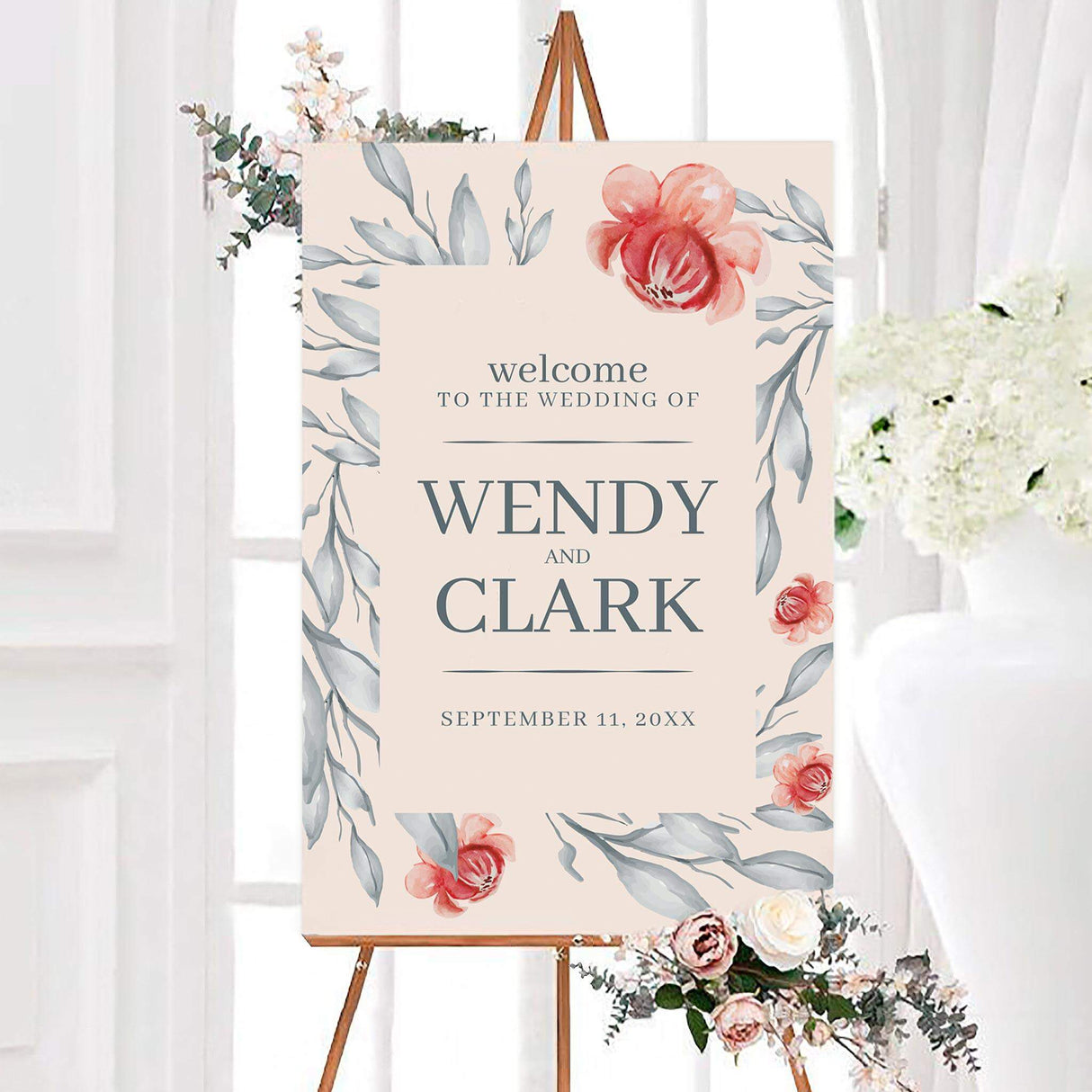 Watercolor orient botanicals wedding welcome sign with coral pink flowers, blue-gray leaves, and a soft blush background. The personalized design features the couple’s names and wedding date in elegant gray serif lettering.