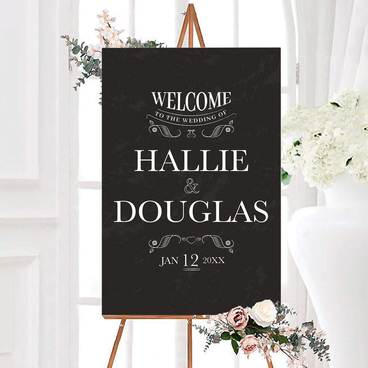 Black ornate chalkboard wedding welcome sign with white serif lettering and decorative hand-drawn flourishes. The personalized design features the couple’s names and wedding date.
