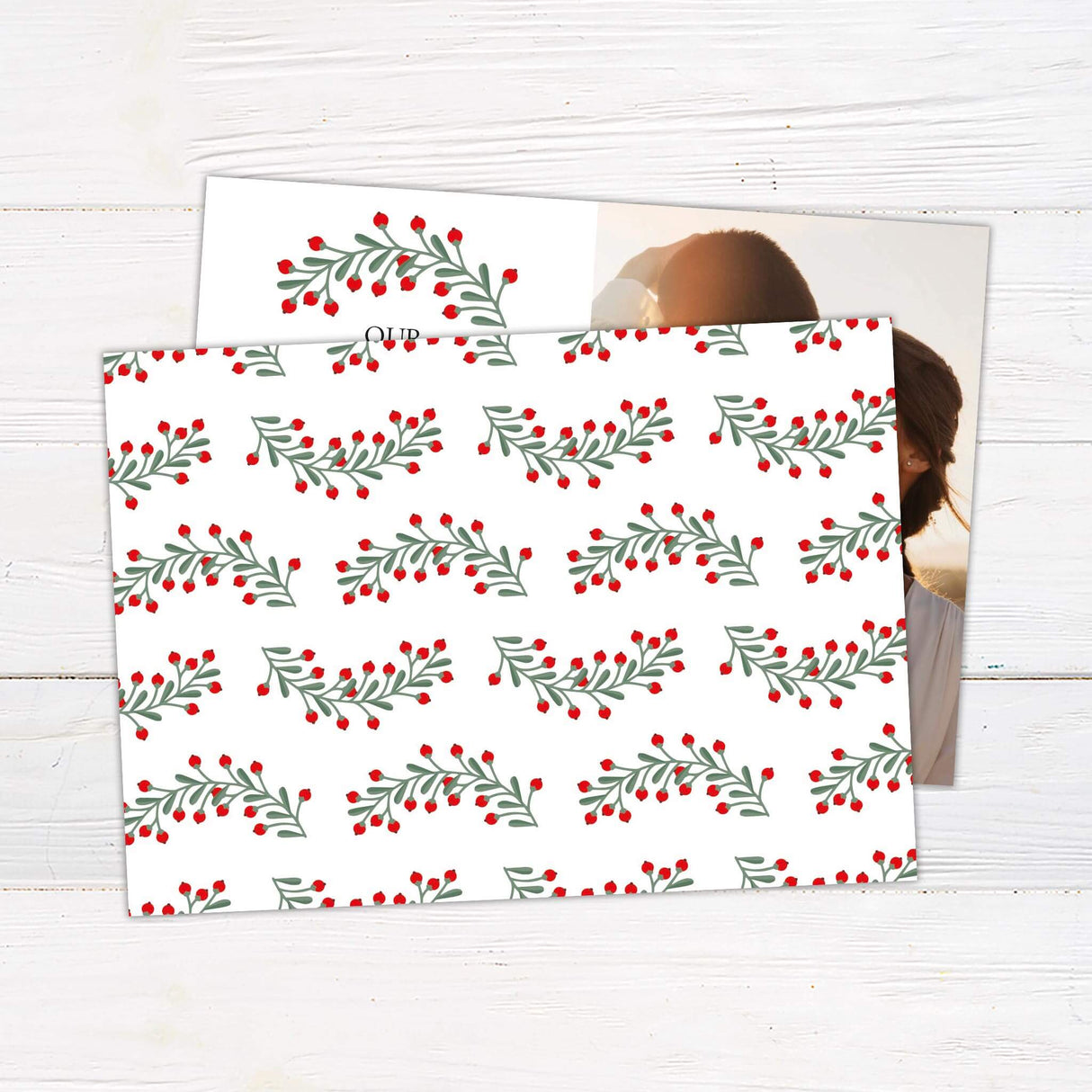 A holiday card with a romantic couple photo on one side and festive text with red berries on the other. The design is warm, simple, and celebratory. - back.