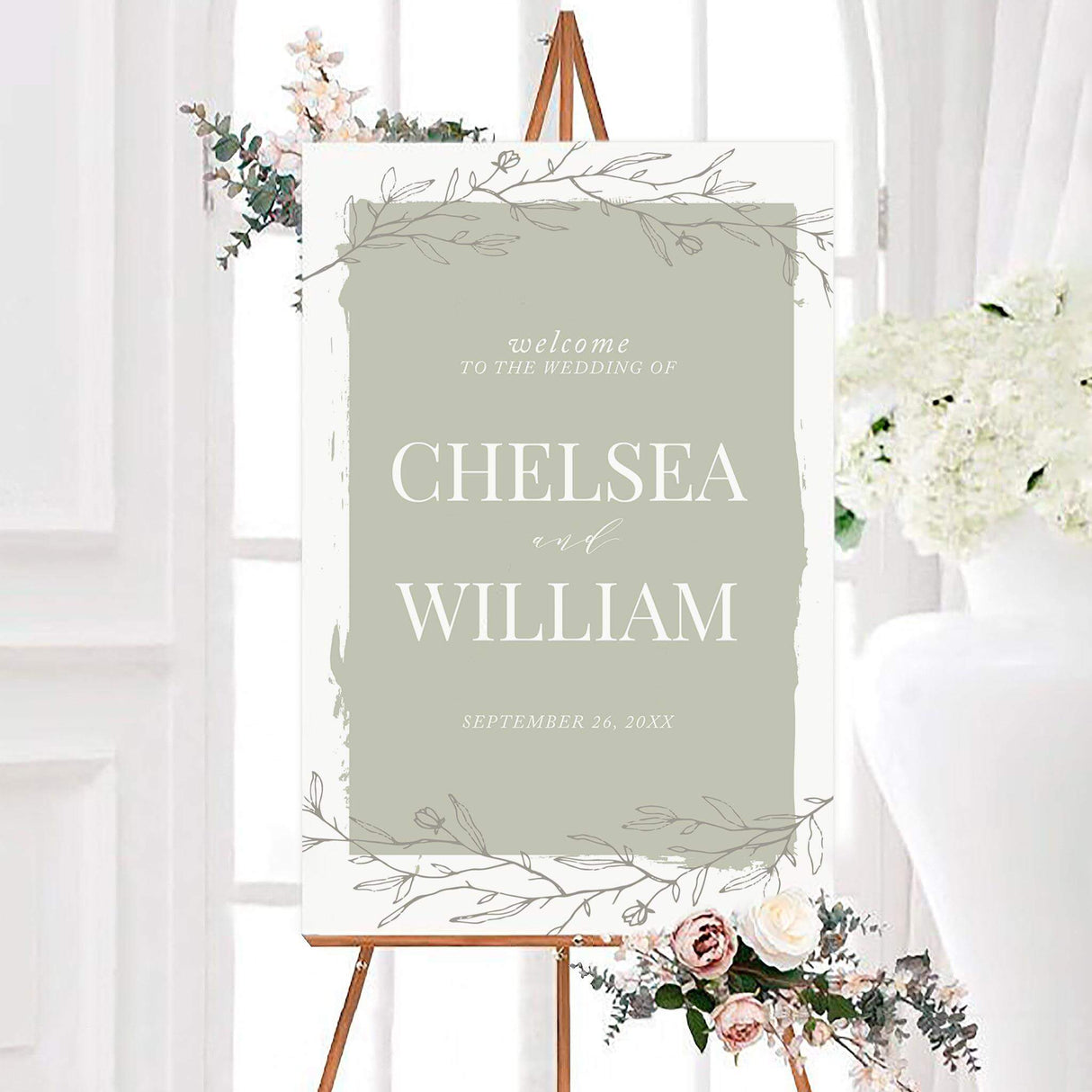 Painted sage green wedding welcome sign featuring delicate hand-drawn botanical branches and an organic painted border. The personalized design includes the couple’s names and wedding date in elegant white typography.