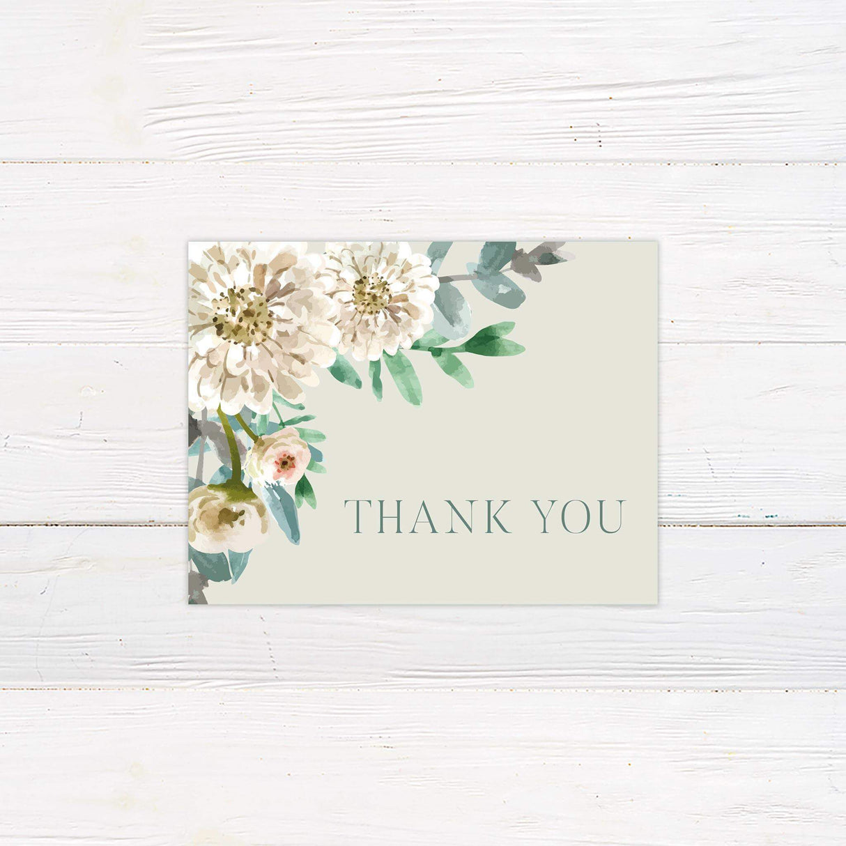 Thank you card with watercolor floral design in white and soft greens, paired with elegant script.