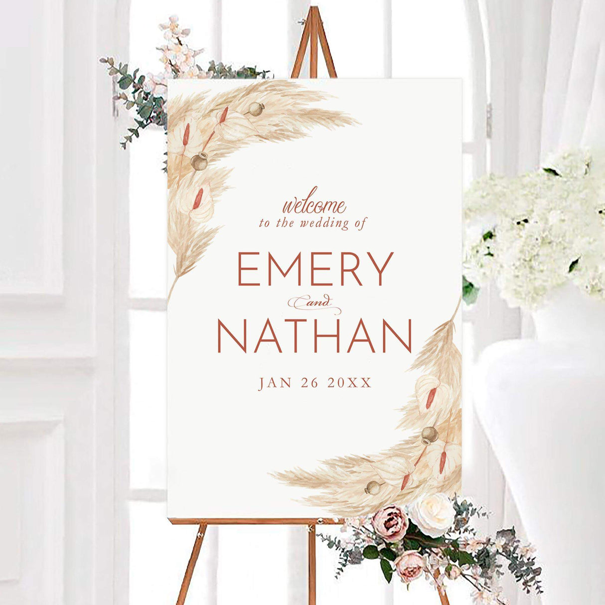 Boho pampas grass wedding welcome sign featuring watercolor pampas grass and neutral botanical accents around a clean white background. The personalized design includes the couple’s names and wedding date in elegant terracotta-toned lettering.