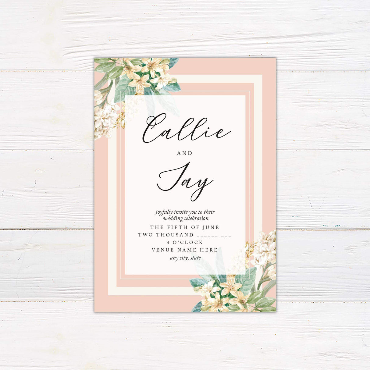 Wedding invitation with blush borders, cream center panel, white flowers, green leaves, and elegant script and serif text.