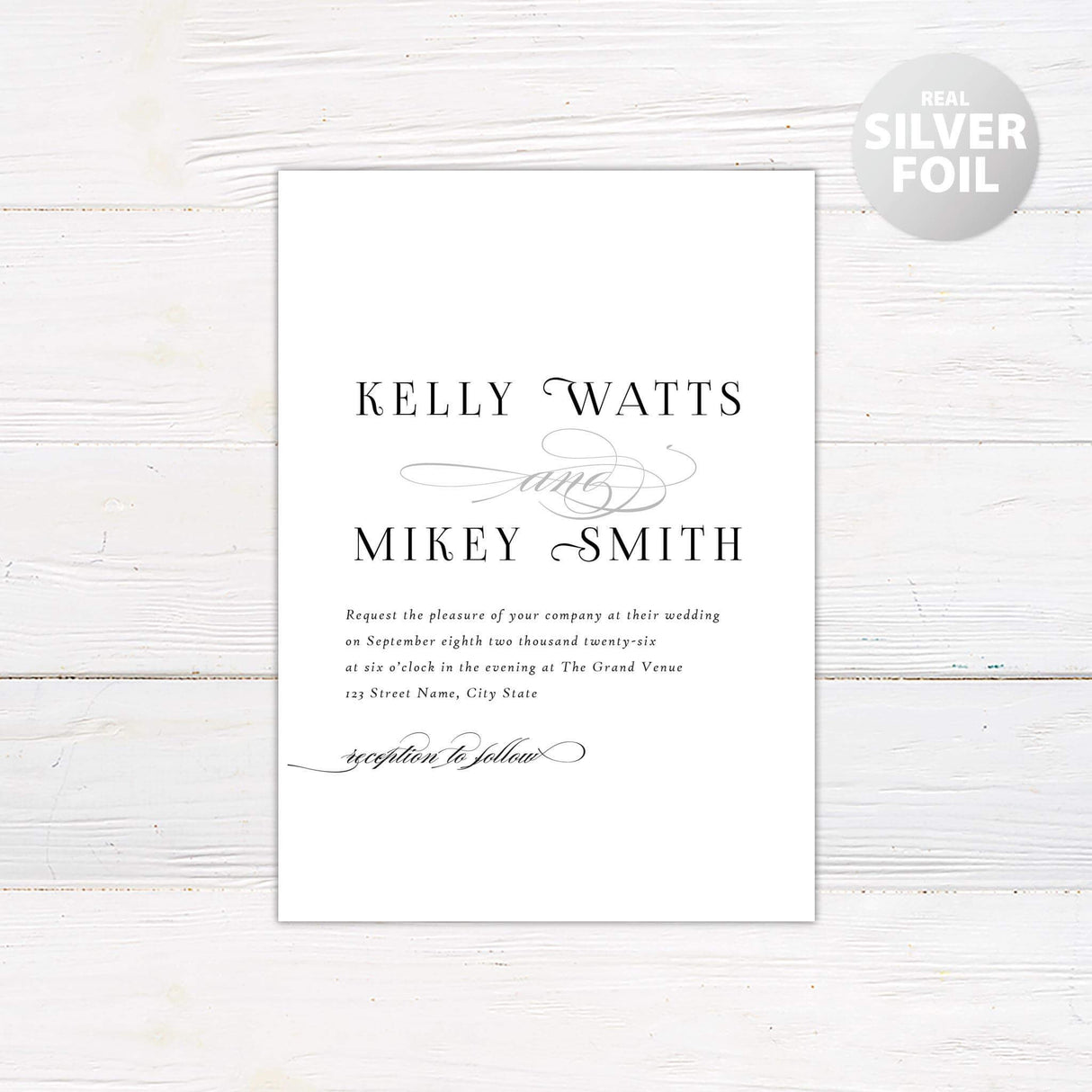 Simple script invitation with mixed fonts. Names of bride and groom in all caps and a simple font with the word and in silver Calligraphy in between.