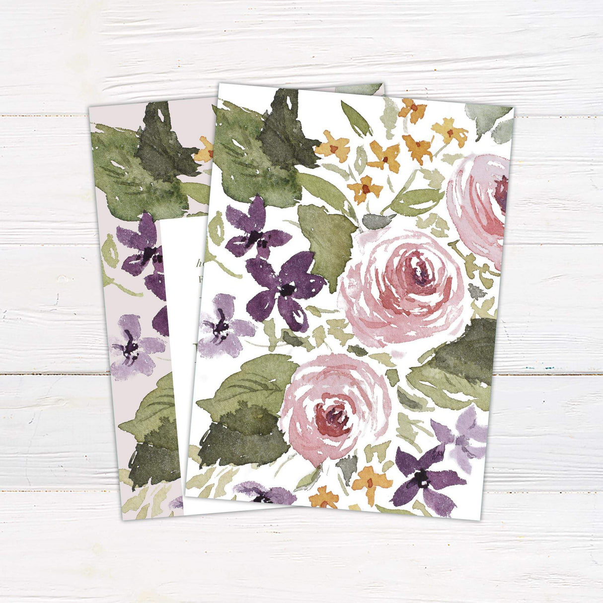 A wedding invitation with a soft neutral background features a bold watercolor floral design in shades of green, purple, pink, and gold. The text is centered within a clean white rectangular box, using a mix of serif and script fonts for an elegant and timeless feel. Event details, including the date, time, and venue, are clearly displayed in a structured layout. This design exudes a romantic and artistic charm, perfect for a garden, vintage, or floral-themed wedding celebration. Back.