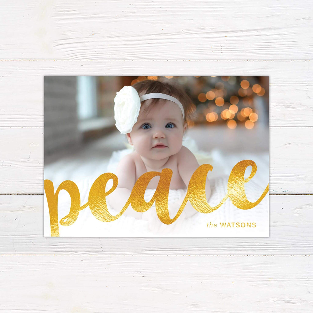 A holiday card design that allows a full photo to cover the entire background. The word "peace" is displayed in bold gold script across the front.