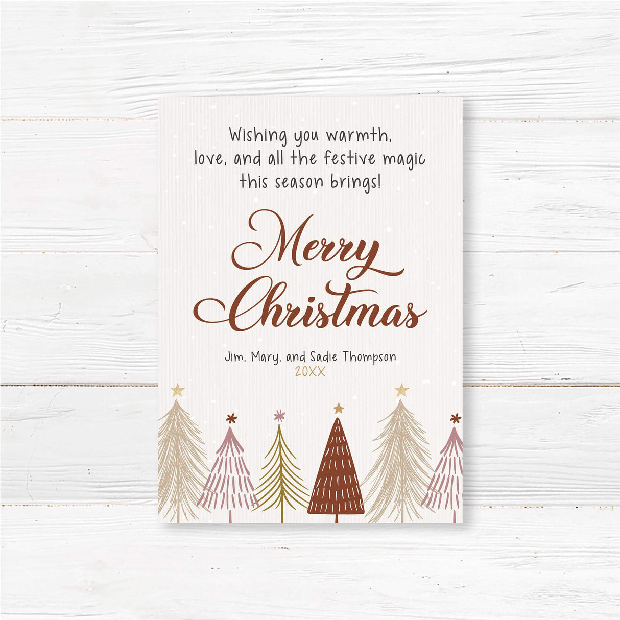 Rustic Christmas card with hand-drawn pine trees, falling snow, and customizable family name and year.