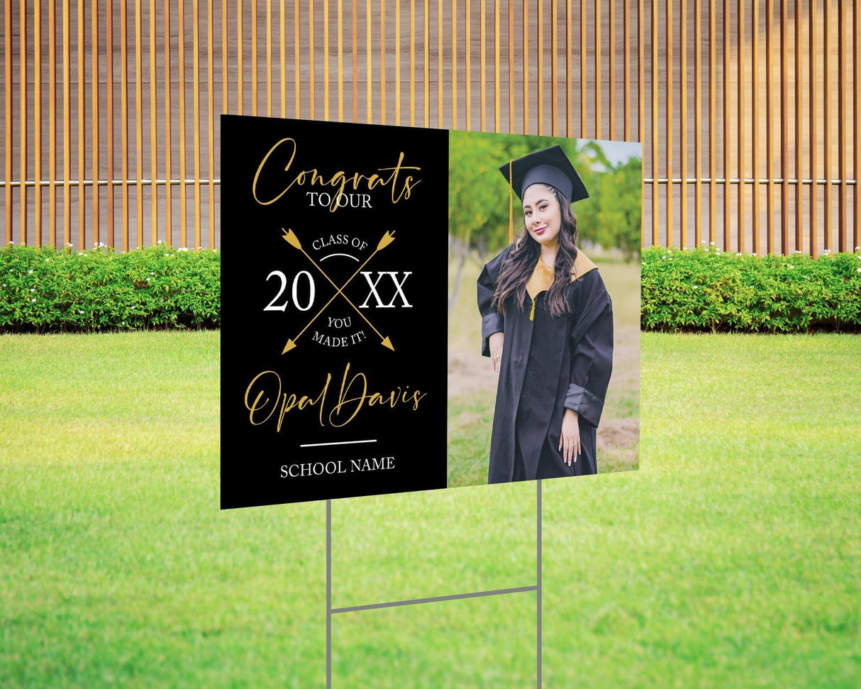 Custom graduation yard sign with a split design, featuring a graduate’s photo on one side and a modern crossed arrows Class Year design with custom school name on the other. Printed on weatherproof Coreplast plastic, available in custom colors and single or double-sided print, perfect for high school and college graduates. Black and gold