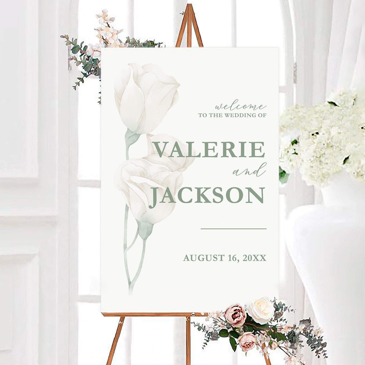 Elegant picked white roses wedding welcome sign featuring soft watercolor white roses and sage green details on a white background. Personalized sage typography displays the couple’s names and wedding date.