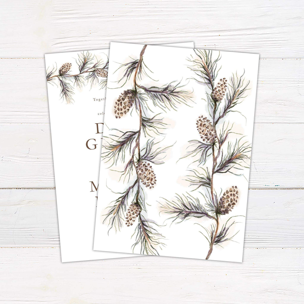 Wedding invitation with pine branch and cone illustration, neutral serif and script fonts on a clean white background - back side
