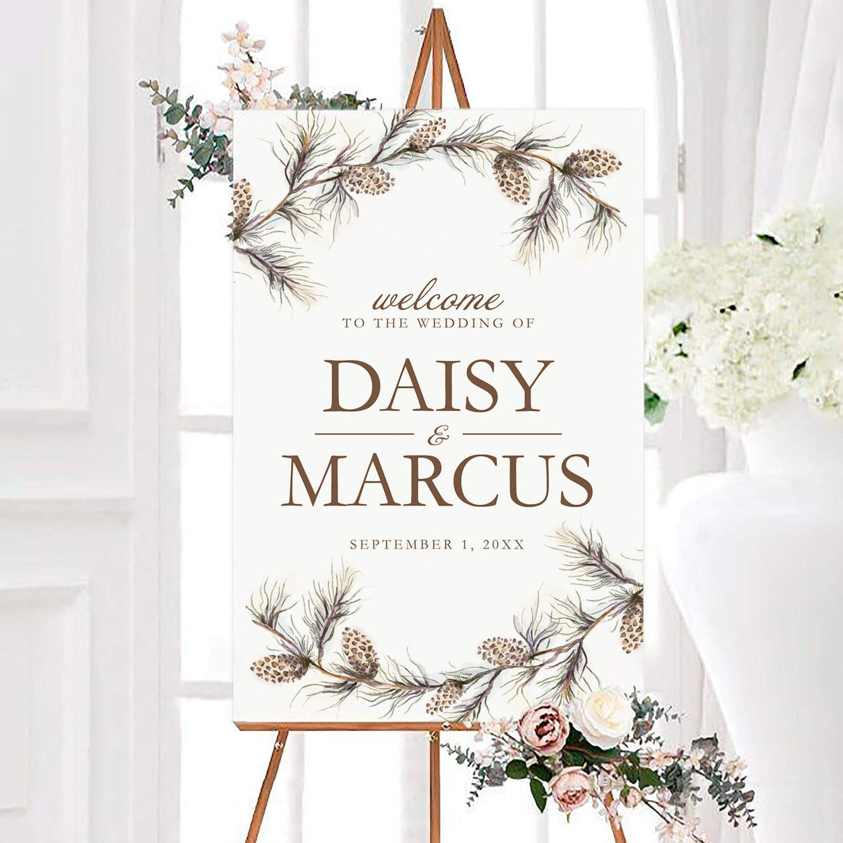 Rustic pine branch wedding welcome sign featuring watercolor pine branches and pinecones around a white background. Personalized brown typography displays the couple’s names and wedding date.