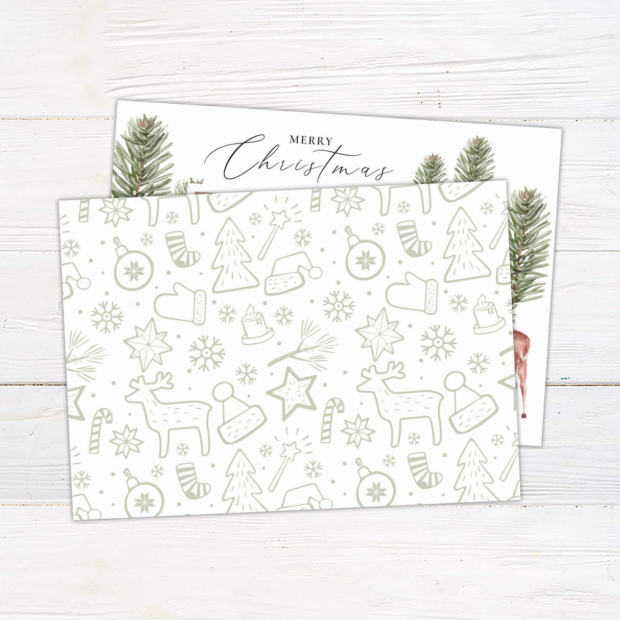 A holiday card design with watercolor pine branches framing a photo and a reindeer illustration on the side. The card layout highlights one large central photo. - back.