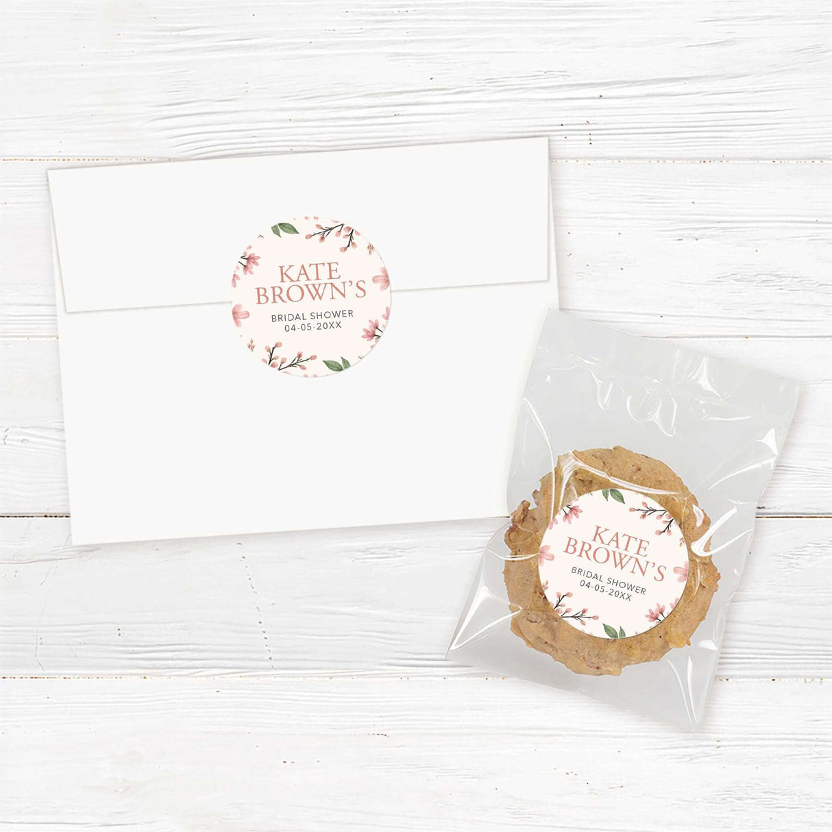 Round bridal shower sticker featuring soft pink blossoms, greenery, and a gold frame, perfect for favors, gifts, and envelope seals.