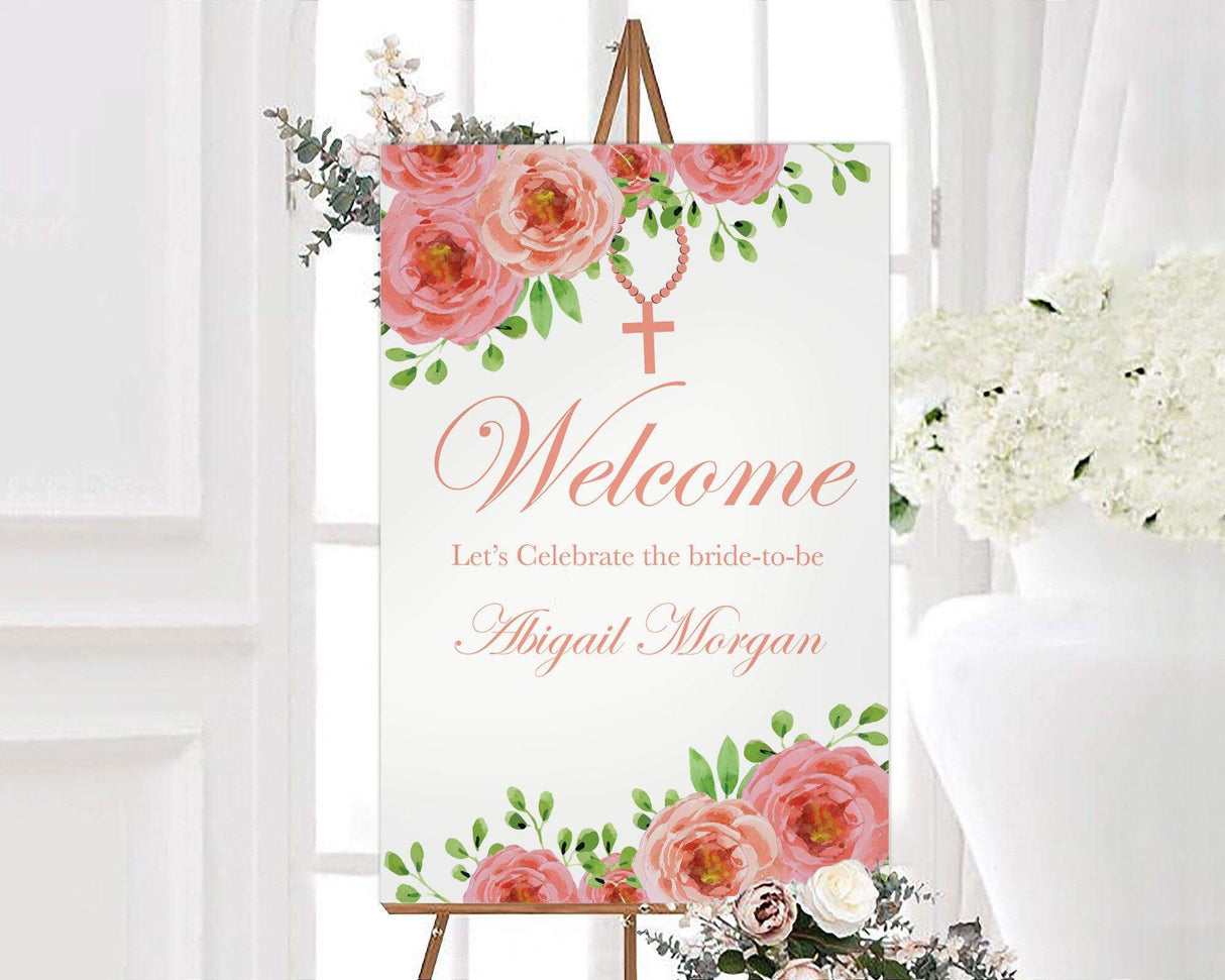 A pink cross floral sign with watercolor flowers and a cross design. The layout features soft colors and elegant text.