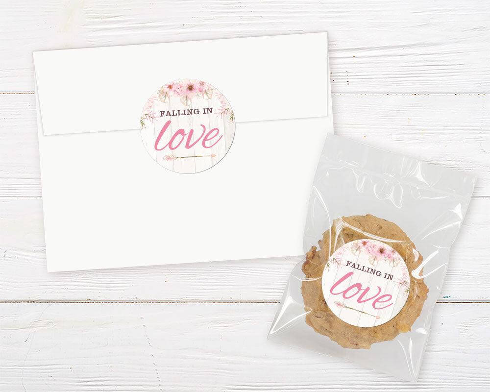 A pink dream catcher floral bridal shower invitation sticker with a dream catcher and soft watercolor flowers. The design features a light wood background with blush floral accents.