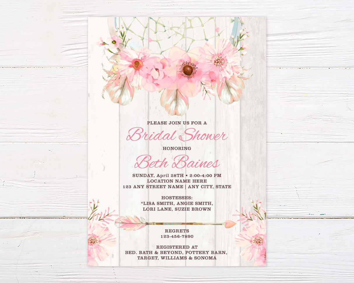 A pink dream catcher floral bridal shower invitation with a dream catcher and soft watercolor flowers. The design features a light wood background with blush floral accents.