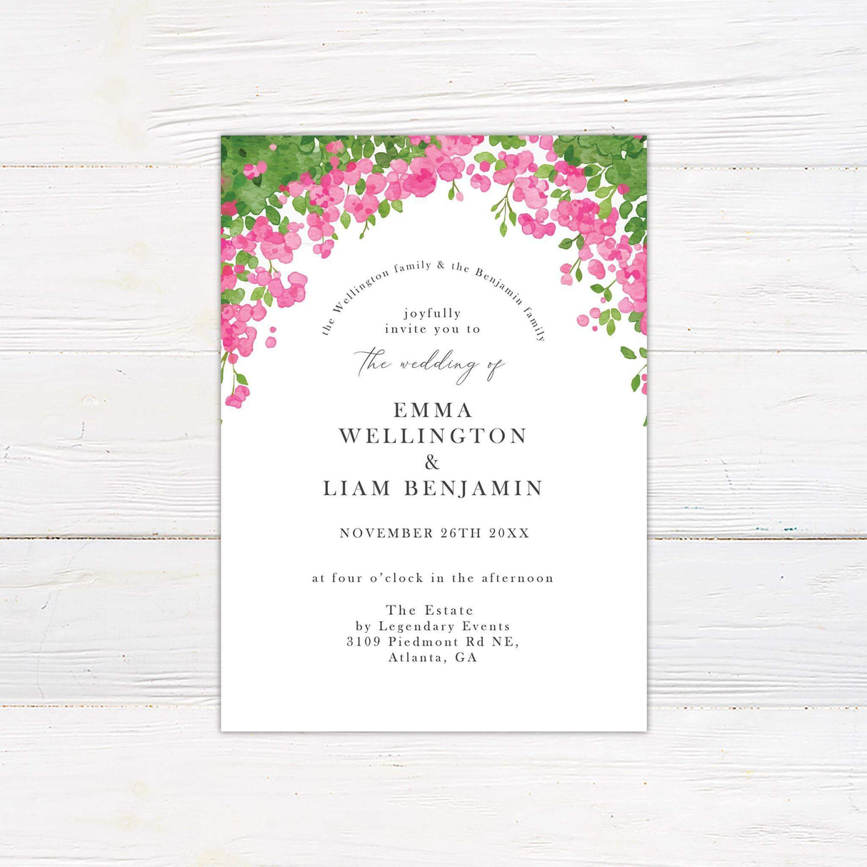 Wedding invitation with bright pink watercolor floral arch, greenery, and elegant serif and script fonts on a white background.